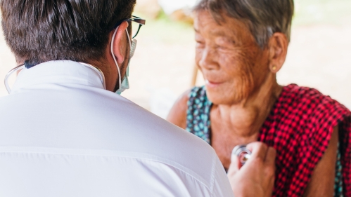 A doctor listens to a patient's heart